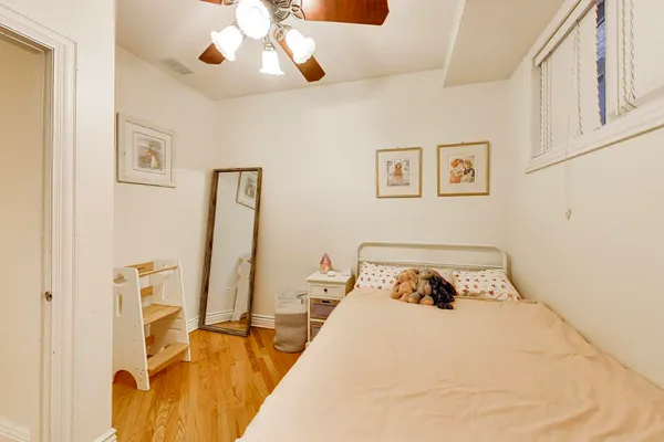 a bedroom with a bed and a flat tv screen on the wall