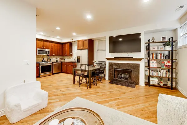 a living room with fireplace furniture and a flat screen tv