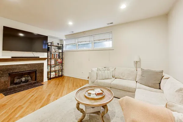 a living room with furniture a flat screen tv and a fireplace
