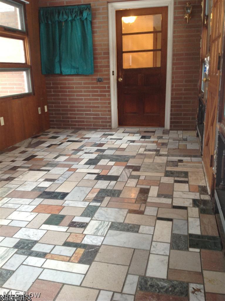 2223 North Hubbard Road Hubbard, OH 44425 - Photo 6 of 16 Marble tiled sun room opens to back patio on the left. View of kitchen entry ahead. Garage behind you.