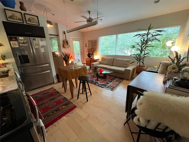 a living room with furniture and a floor to ceiling window