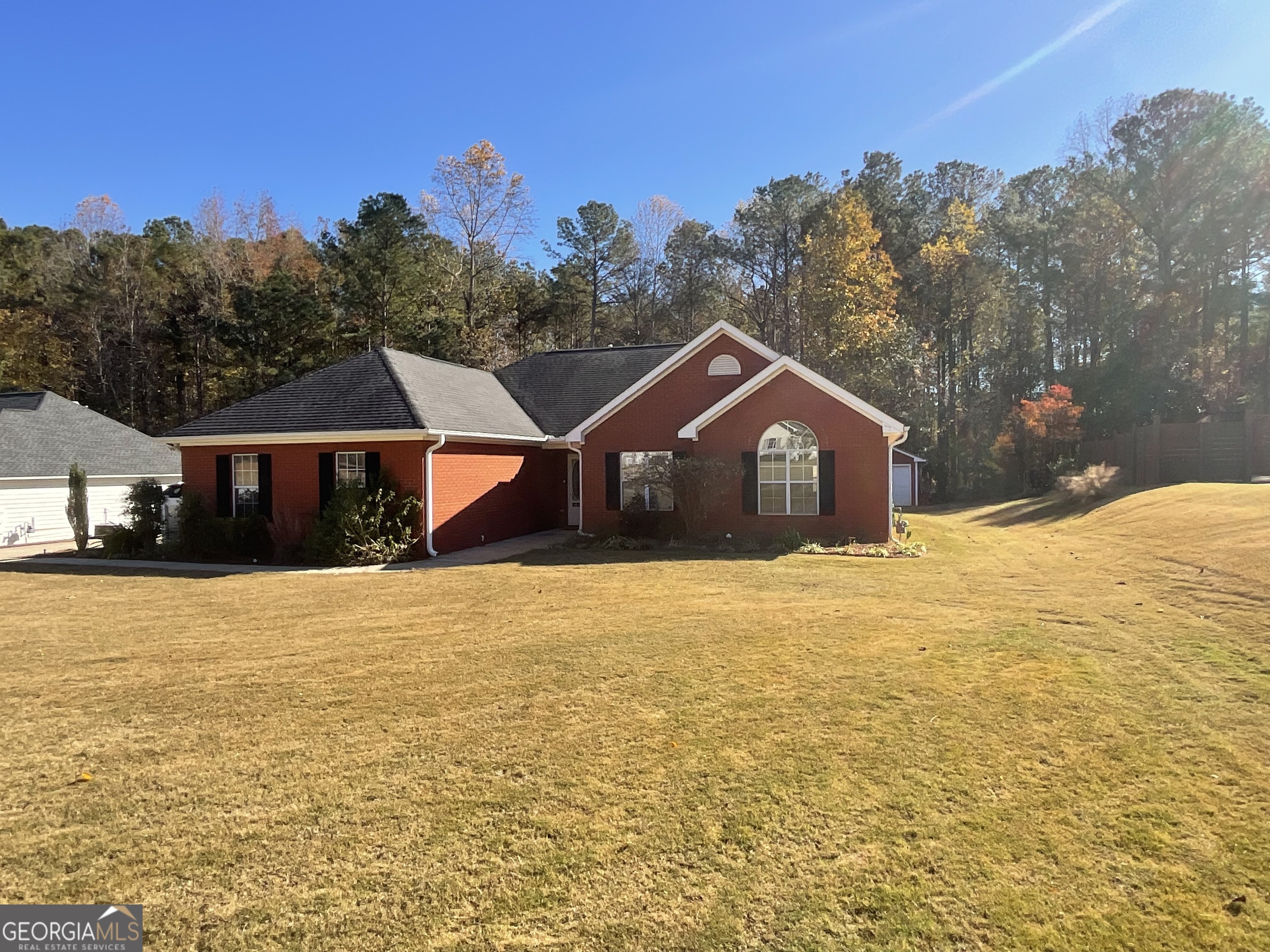a house with yard and tree in the background