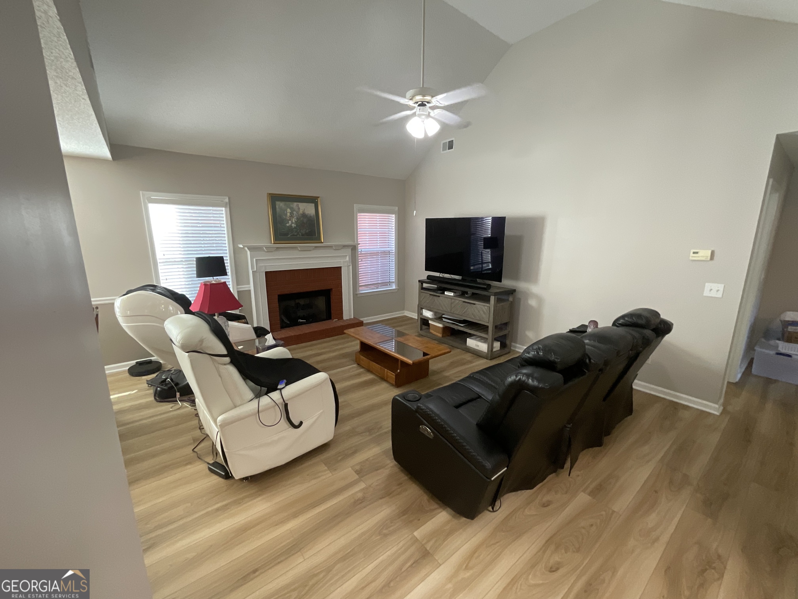 45 Riverside Walk Sharpsburg, GA 30277 - Photo 11 of 25 a living room with furniture a fireplace and a flat screen tv