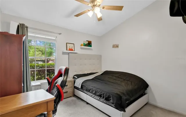 a bed sitting in a bedroom next to a window