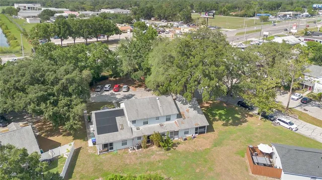 an aerial view of a house with a yard and lake view