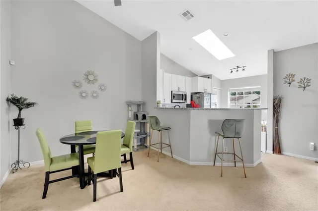 a view of a dining room with workspace and a window