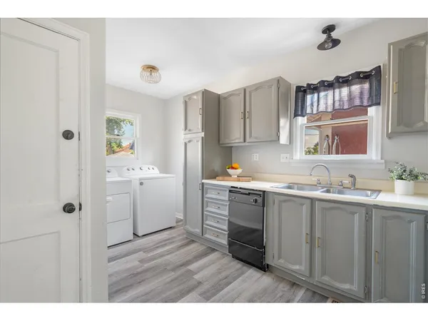 a kitchen with a sink cabinets and window
