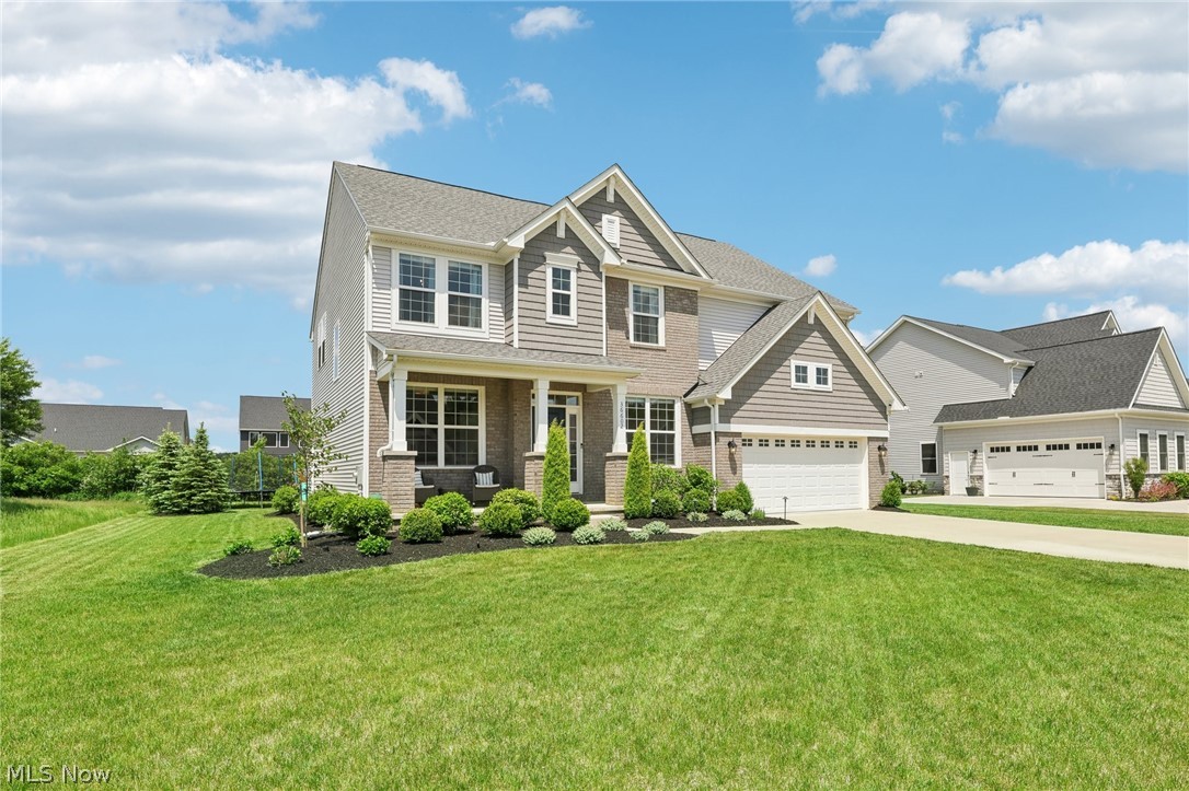 36602 Amalfi Road North Ridgeville, OH 44039 - Photo 25 of 49 Craftsman-style house featuring a garage and a front yard