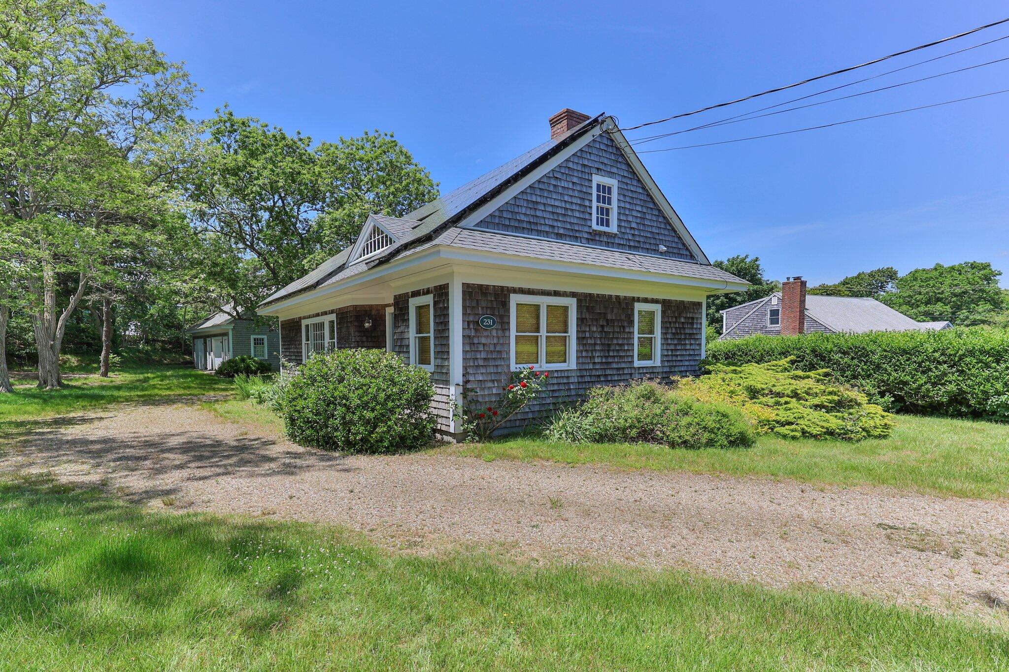 231 Crowell Road Chatham, MA 02633 - Photo 21 of 27 a front view of a house with a garden