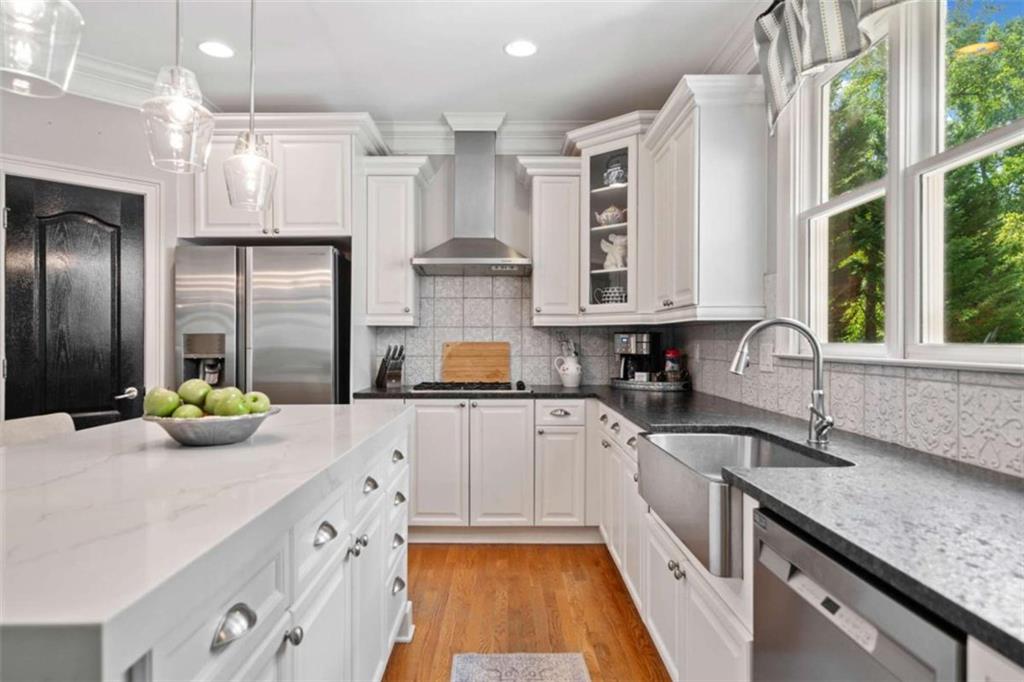 380 Creek Point Milton, GA 30004 - Photo 13 of 74 a kitchen with stainless steel appliances a sink a stove a refrigerator and window