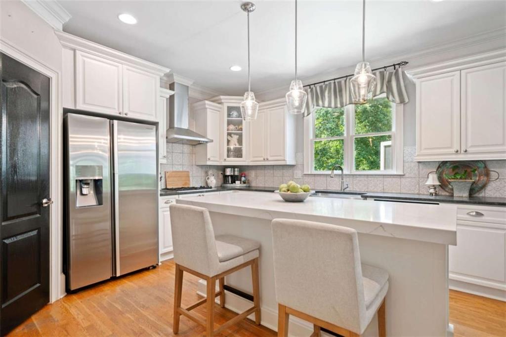 380 Creek Point Milton, GA 30004 - Photo 14 of 74 a kitchen with stainless steel appliances granite countertop a refrigerator a sink dishwasher a stove with white cabinets and wooden floor