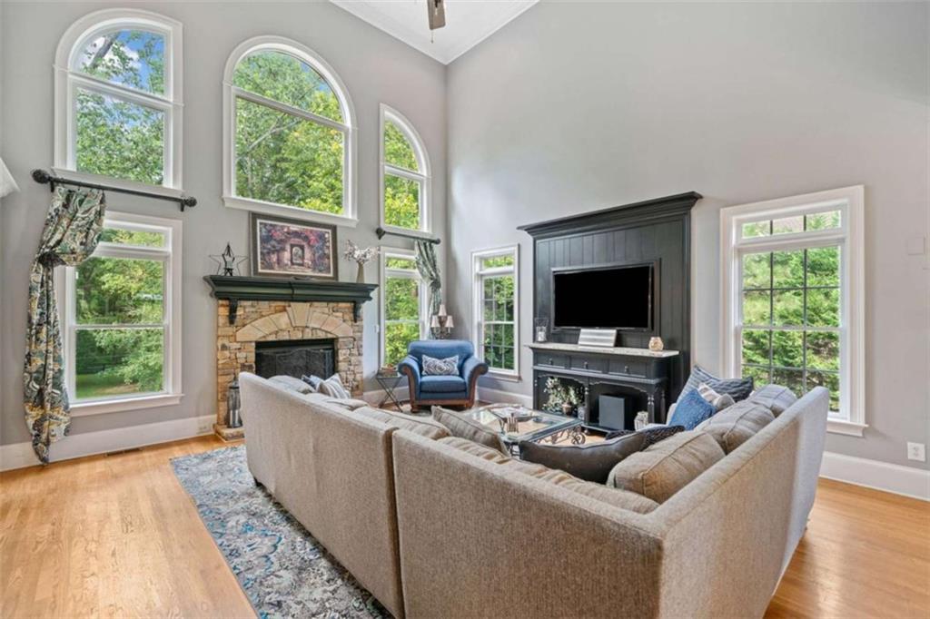 380 Creek Point Milton, GA 30004 - Photo 18 of 74 a living room with furniture a flat screen tv and a fireplace