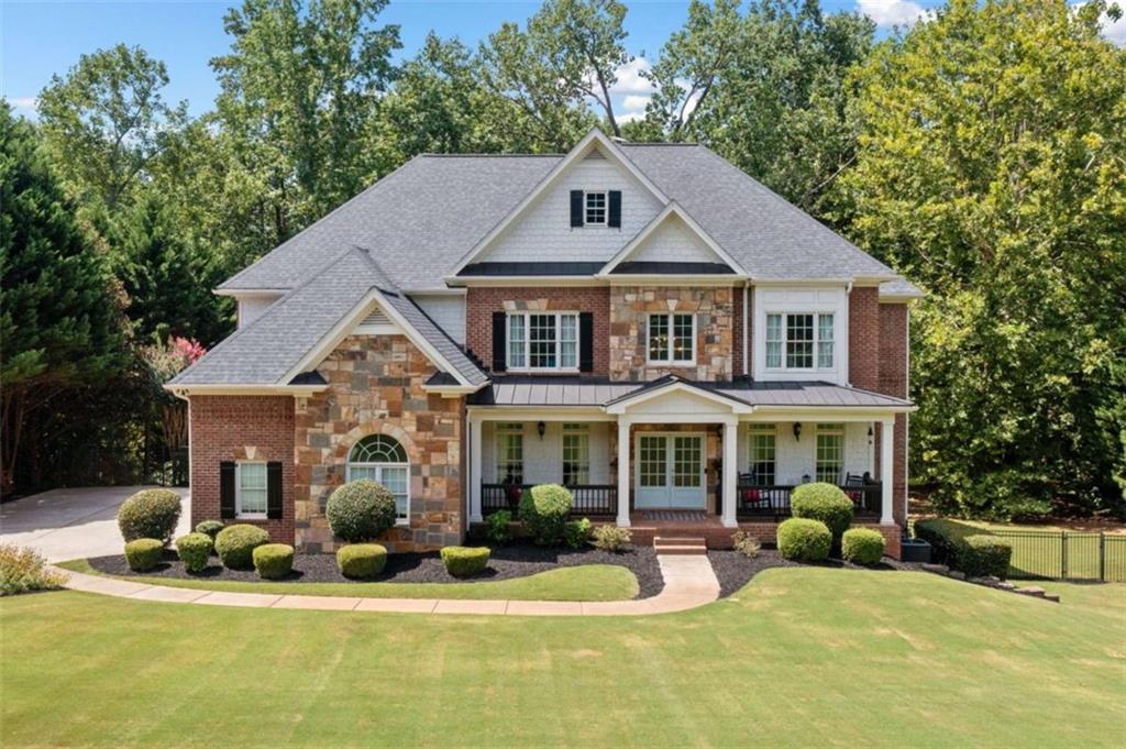 380 Creek Point Milton, GA 30004 - Photo 2 of 74 a front view of a house with swimming pool and porch