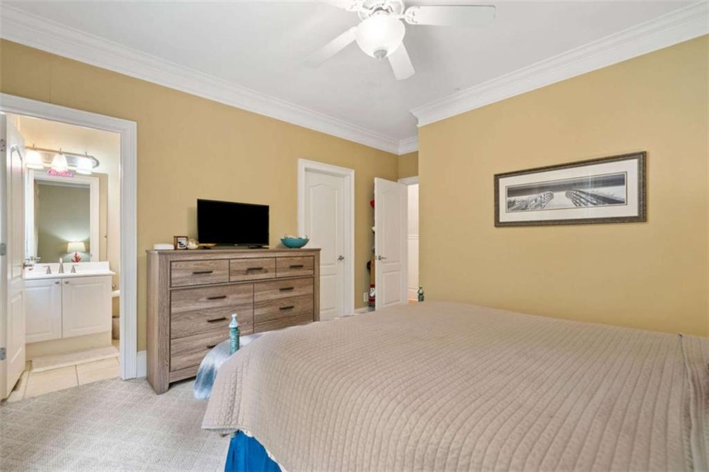 380 Creek Point Milton, GA 30004 - Photo 30 of 74 a bedroom with a bed and a flat screen tv