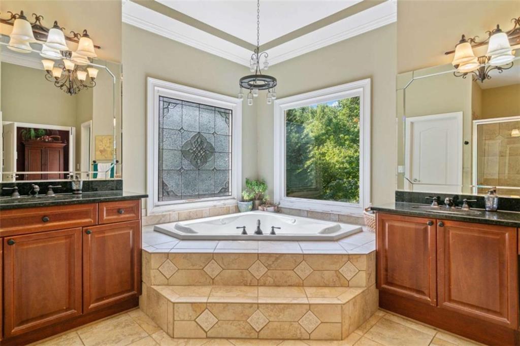 380 Creek Point Milton, GA 30004 - Photo 39 of 74 a spacious bathroom with a tub sink and mirror