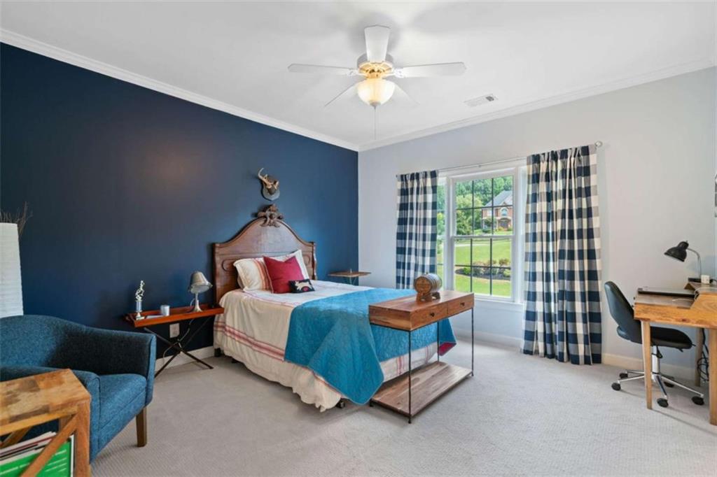 380 Creek Point Milton, GA 30004 - Photo 43 of 74 a bedroom with bed and a chandelier