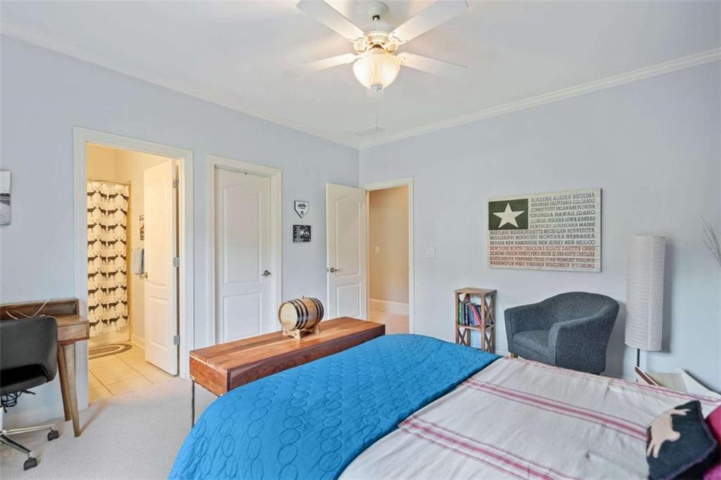 380 Creek Point Milton, GA 30004 - Photo 44 of 74 a bedroom with a bed and a chandelier