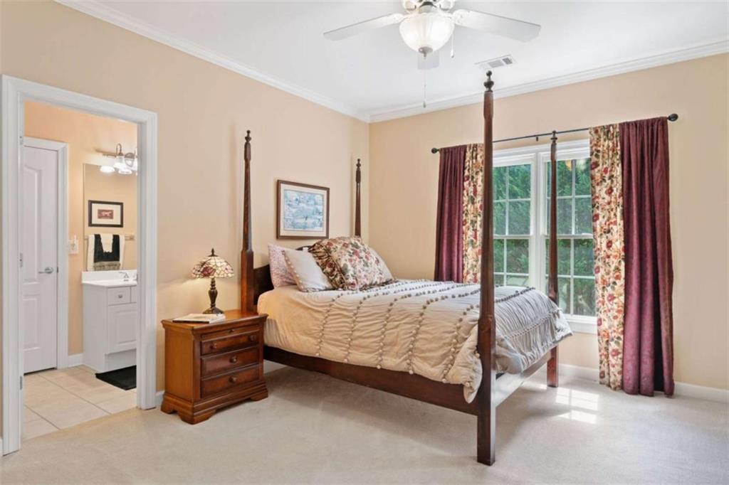 380 Creek Point Milton, GA 30004 - Photo 46 of 74 a bedroom with a bed and a chandelier