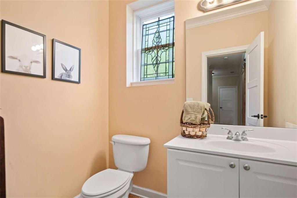 380 Creek Point Milton, GA 30004 - Photo 55 of 74 a bathroom with a toilet a sink and mirror
