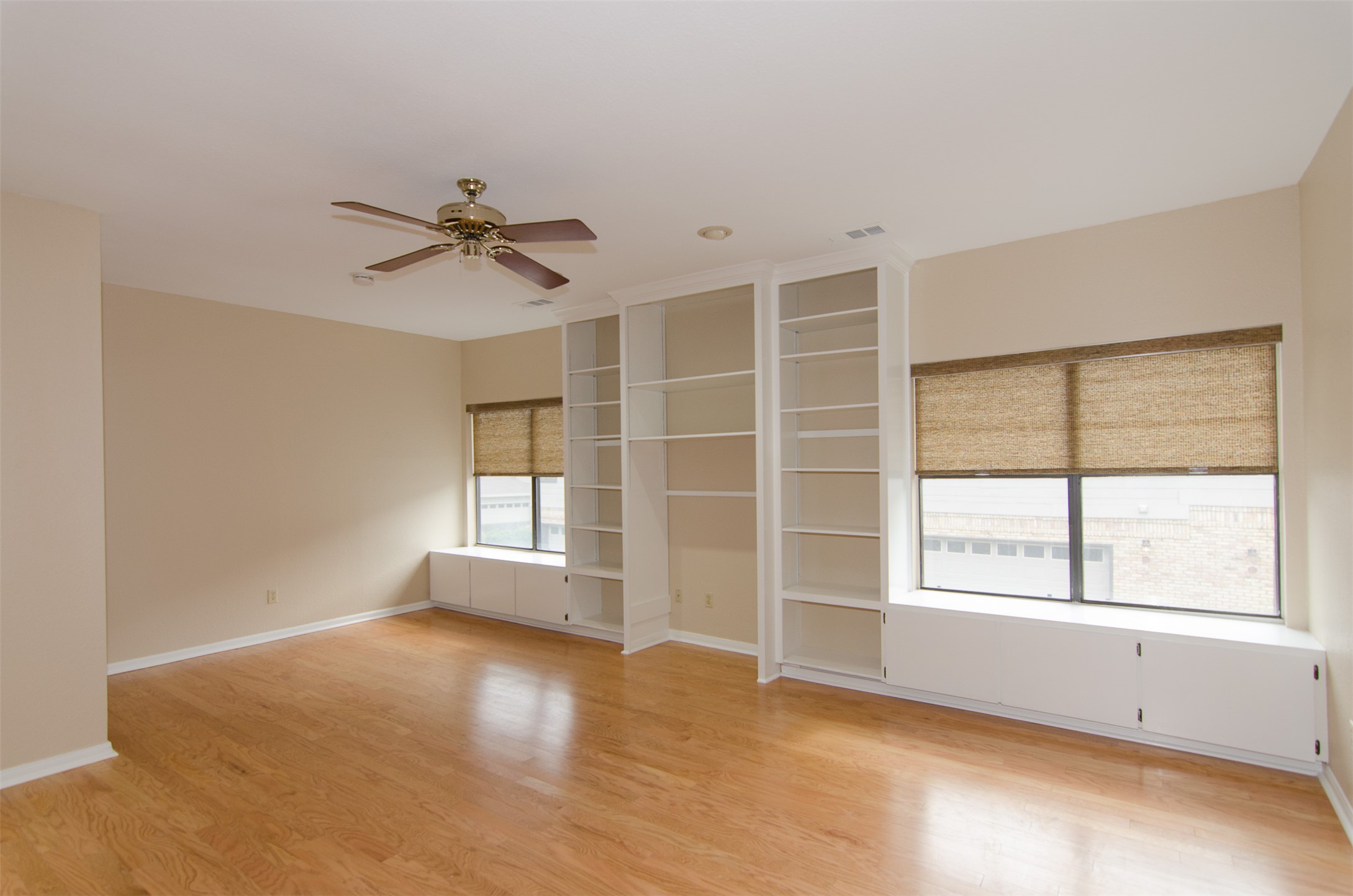 10819 Crown Colony Drive, Unit 38 Austin, TX 78747 - Photo 12 of 28 an empty room with windows and chandelier fan