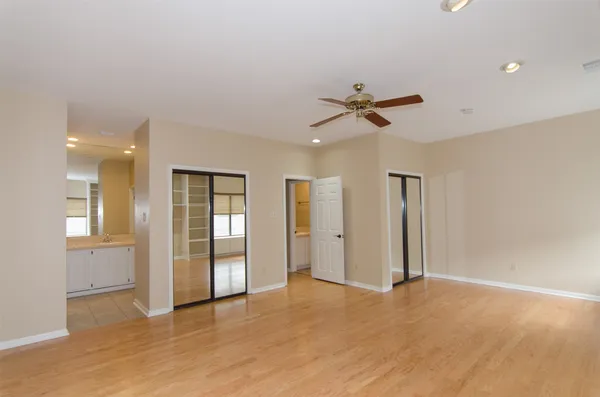 an empty room with fan and entrance