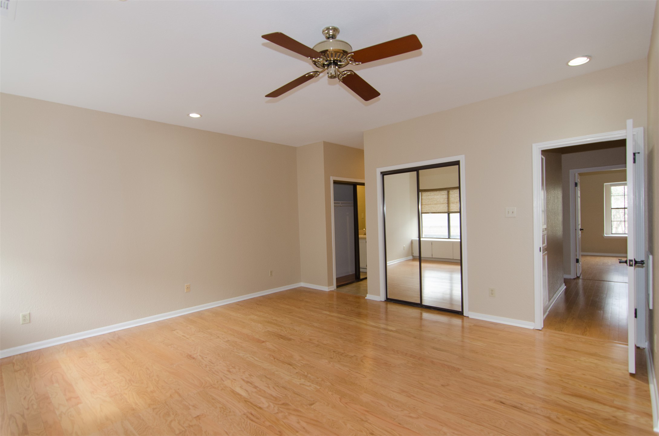 10819 Crown Colony Drive, Unit 38 Austin, TX 78747 - Photo 14 of 28 wooden floor in an empty room with a window
