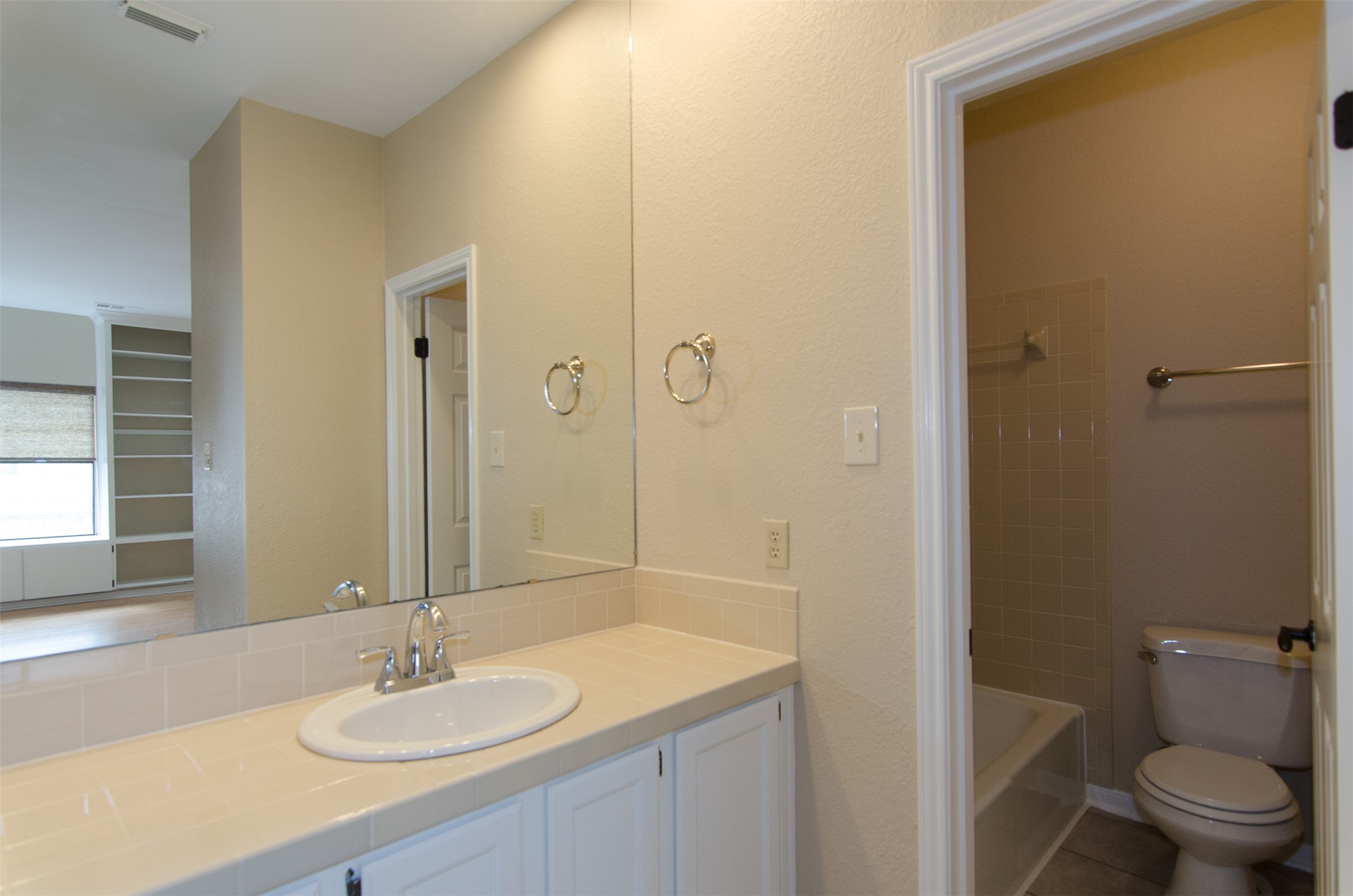 10819 Crown Colony Drive, Unit 38 Austin, TX 78747 - Photo 17 of 28 a bathroom with a sink toilet and shower