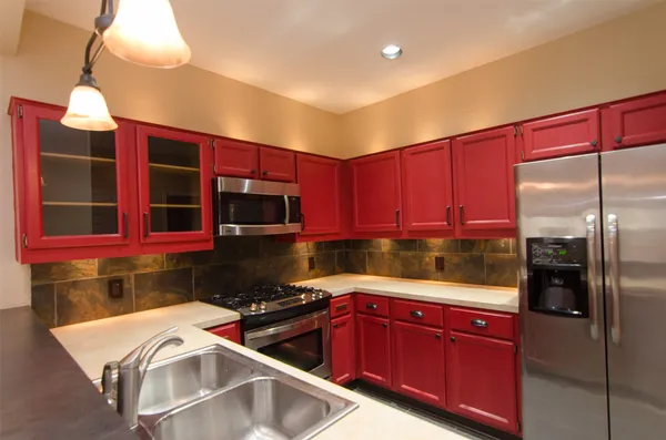 a kitchen with stainless steel appliances granite countertop a refrigerator and a sink