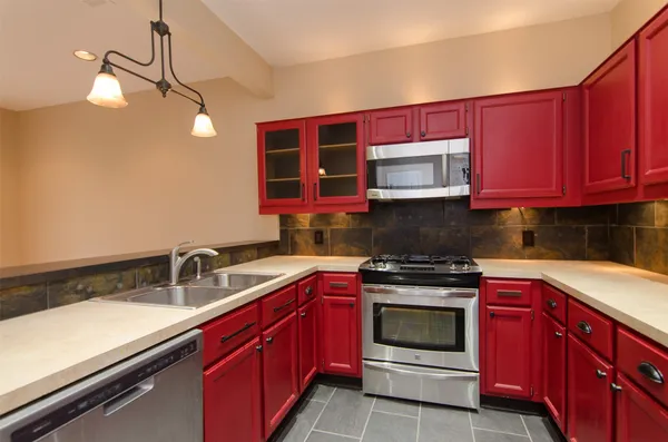a kitchen with stainless steel appliances a stove sink and cabinets