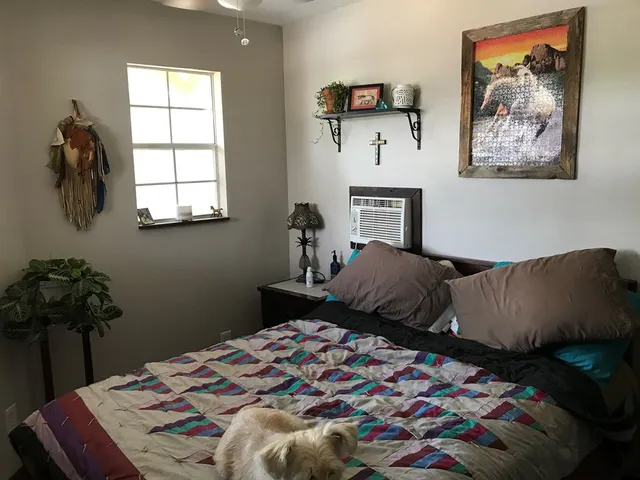 a view of staircase with lots of frames on wall and a window