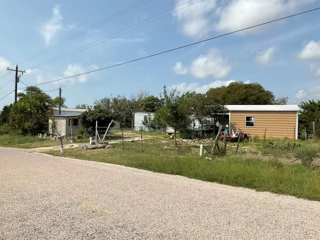 a view of a house with a yard and a garage