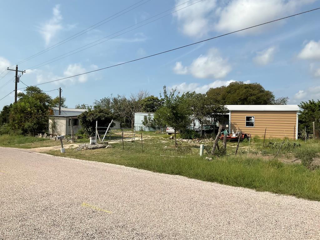 313 Elm Pass II Road East Center Point, TX 78010 - Photo 2 of 37 a view of a house with a yard and a garage