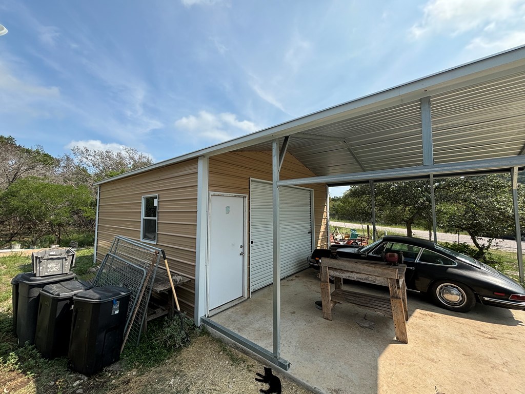 313 Elm Pass II Road East Center Point, TX 78010 - Photo 9 of 37 a view of a two chairs in the back yard of the house