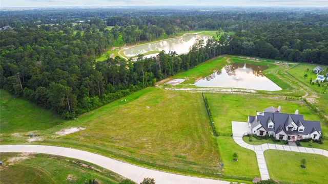 an aerial view of a residential houses with outdoor space