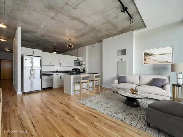 a living room with lots of furniture and kitchen view