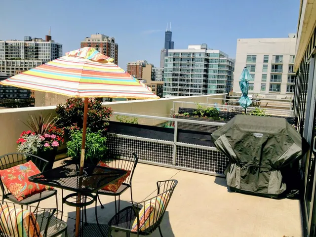 a view of a patio with a table and chairs and potted plants