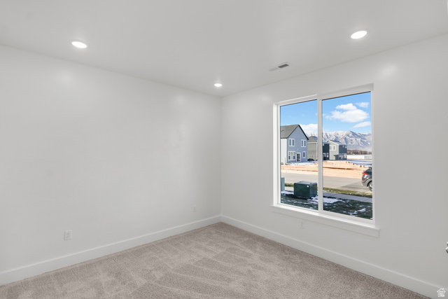 537 South Rivergate Drive Logan, UT 84321 - Photo 7 of 20 Bright room featuring a large picture window, recessed lighting, white walls, and neutral carpeting