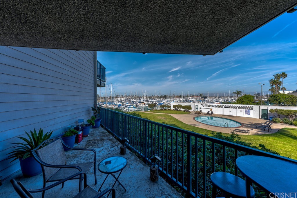 3101 Peninsula Road, Unit 108 Oxnard, CA 93035 - Photo 2 of 24 a view of a balcony with chair and table