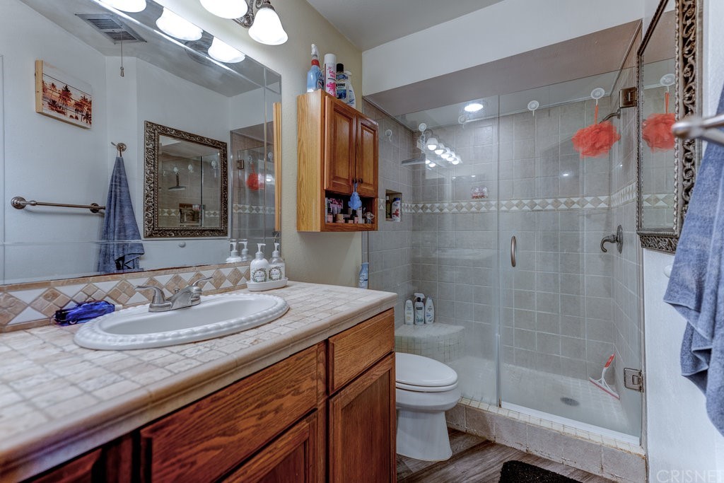 3101 Peninsula Road, Unit 108 Oxnard, CA 93035 - Photo 11 of 24 a bathroom with a granite countertop sink a toilet and shower