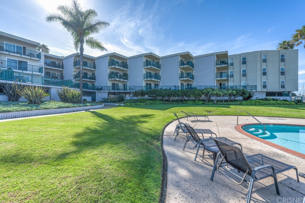 3101 Peninsula Road, Unit 108 Oxnard, CA 93035 - Photo 13 of 24 a view of a chairs and table in the patio next to a yard