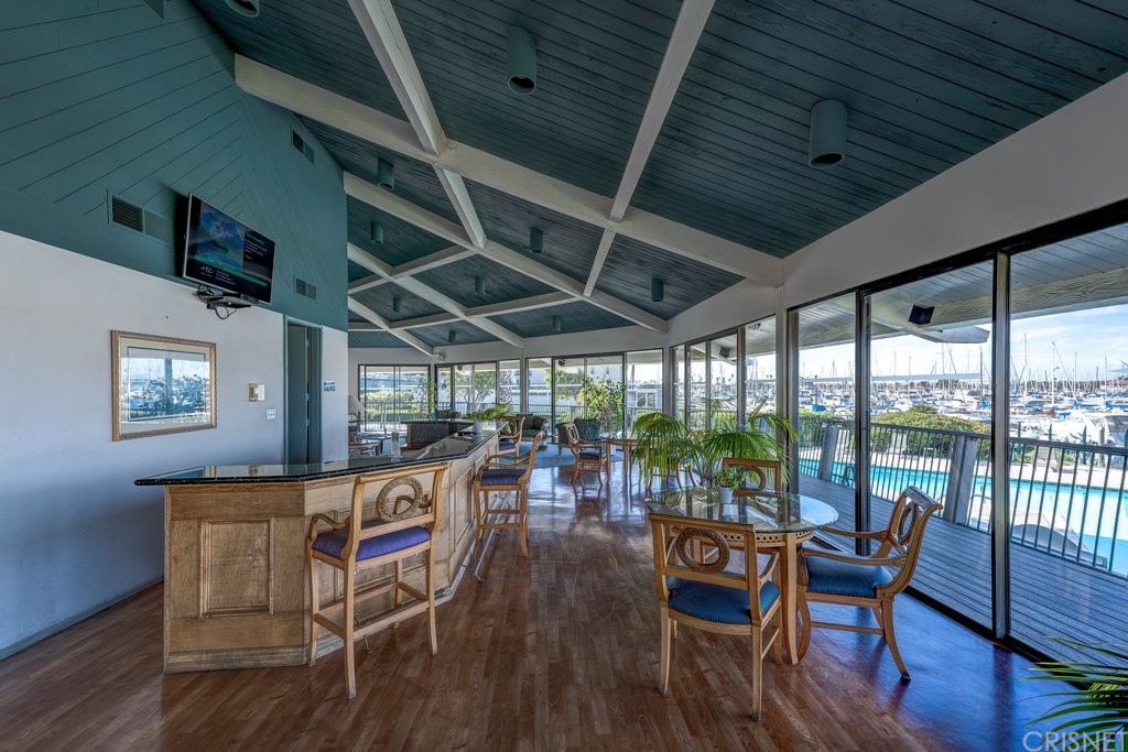 3101 Peninsula Road, Unit 108 Oxnard, CA 93035 - Photo 23 of 24 a view of a dining room with furniture window and wooden floor