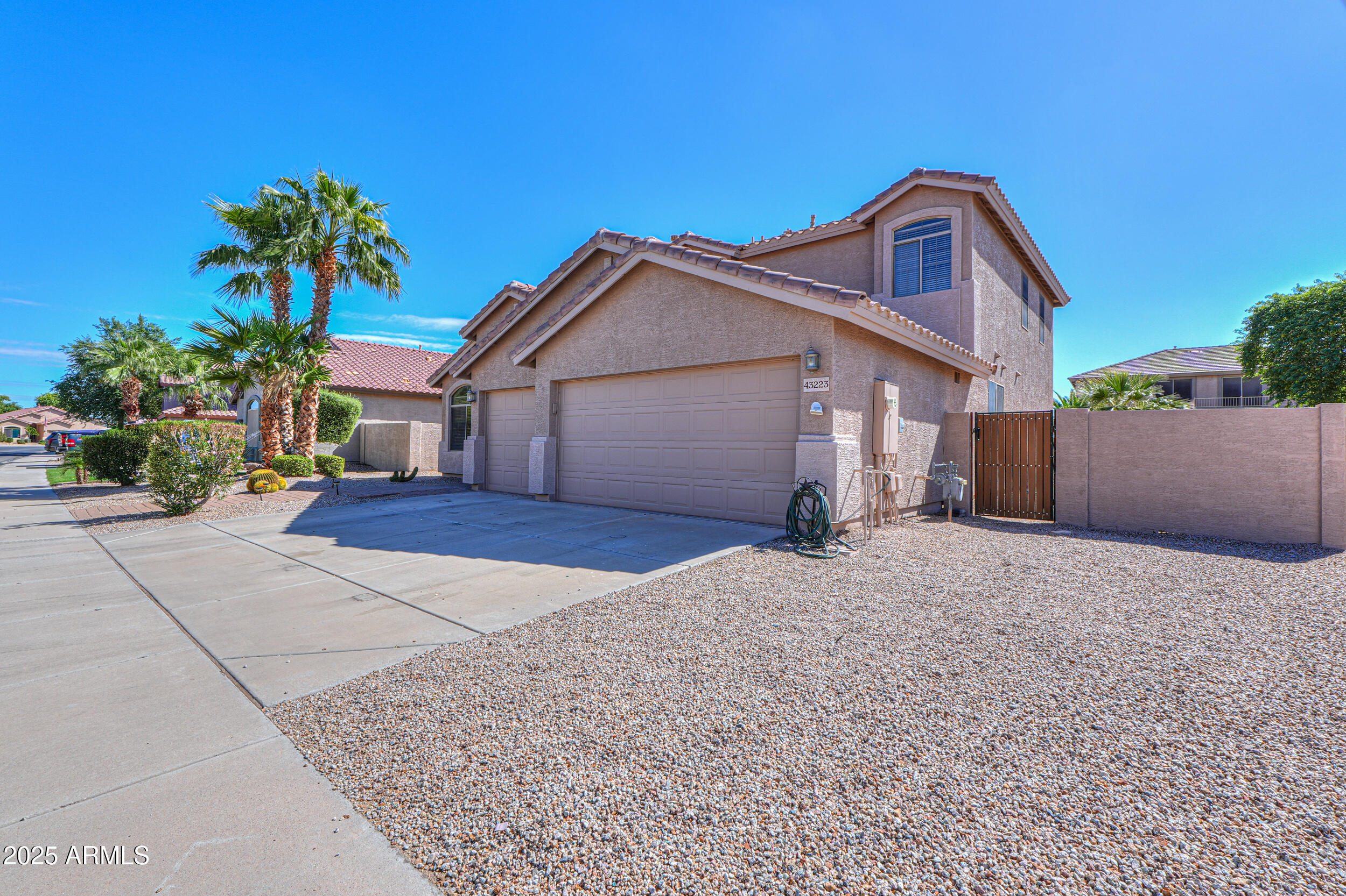 43223 West Venture Road Maricopa, AZ 85138 - Photo 18 of 70 a front view of a house with a yard and garage