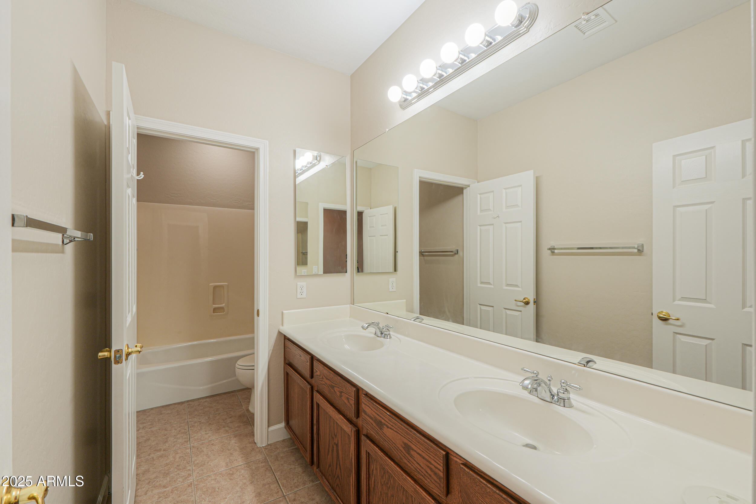 43223 West Venture Road Maricopa, AZ 85138 - Photo 47 of 70 a bathroom with a double vanity sink a mirror and a shower
