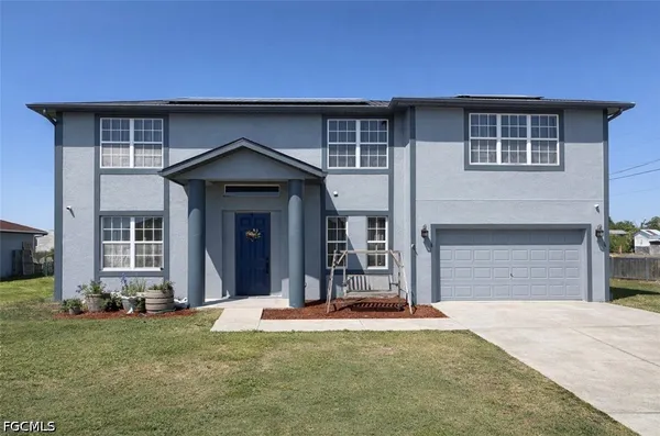 a front view of a house with a yard
