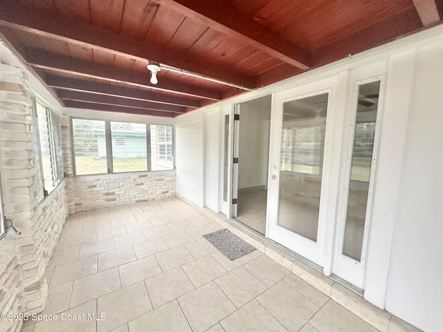 a view of an empty room with glass door