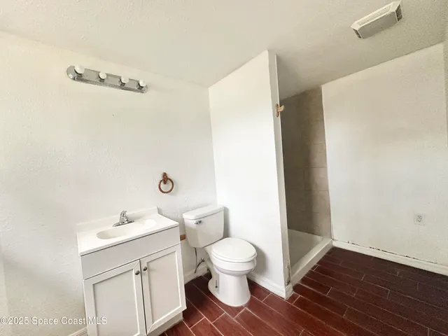 a bathroom with a toilet a sink and a mirror