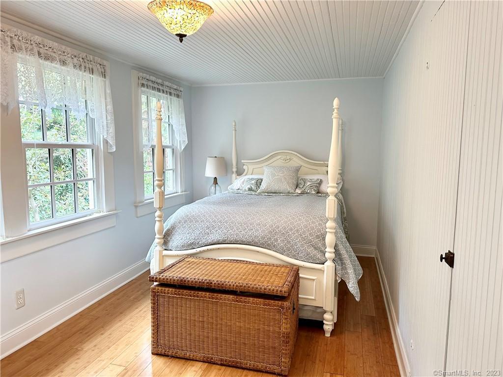15 Tuxis Road Madison, CT 06443 - Photo 12 of 27 a bedroom with a bed and wooden floor