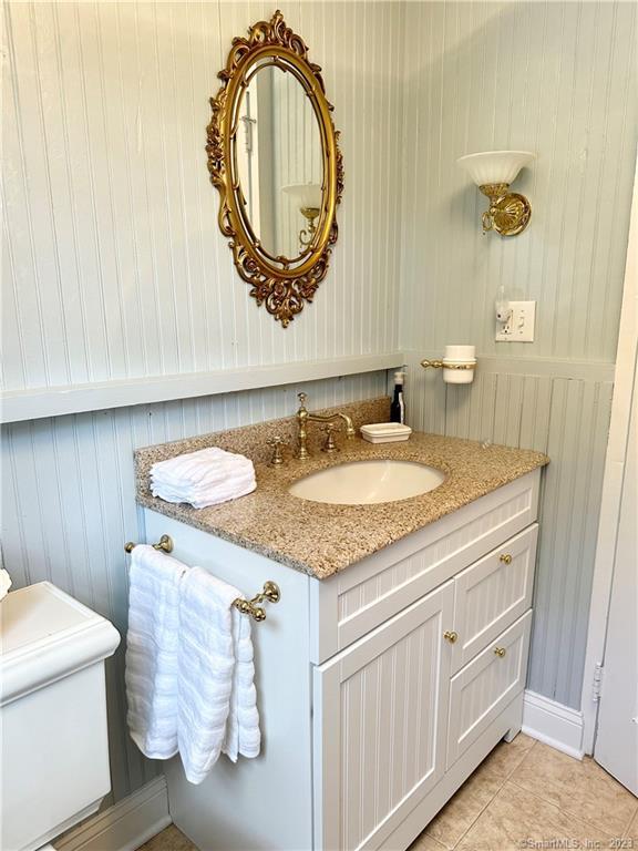 15 Tuxis Road Madison, CT 06443 - Photo 14 of 27 a bathroom with a granite countertop sink and a mirror