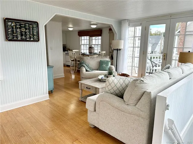 a living room with furniture and large windows