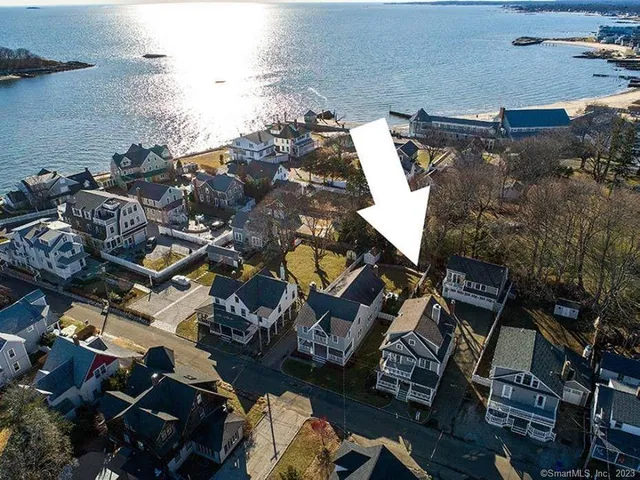 an aerial view of multiple houses with yard